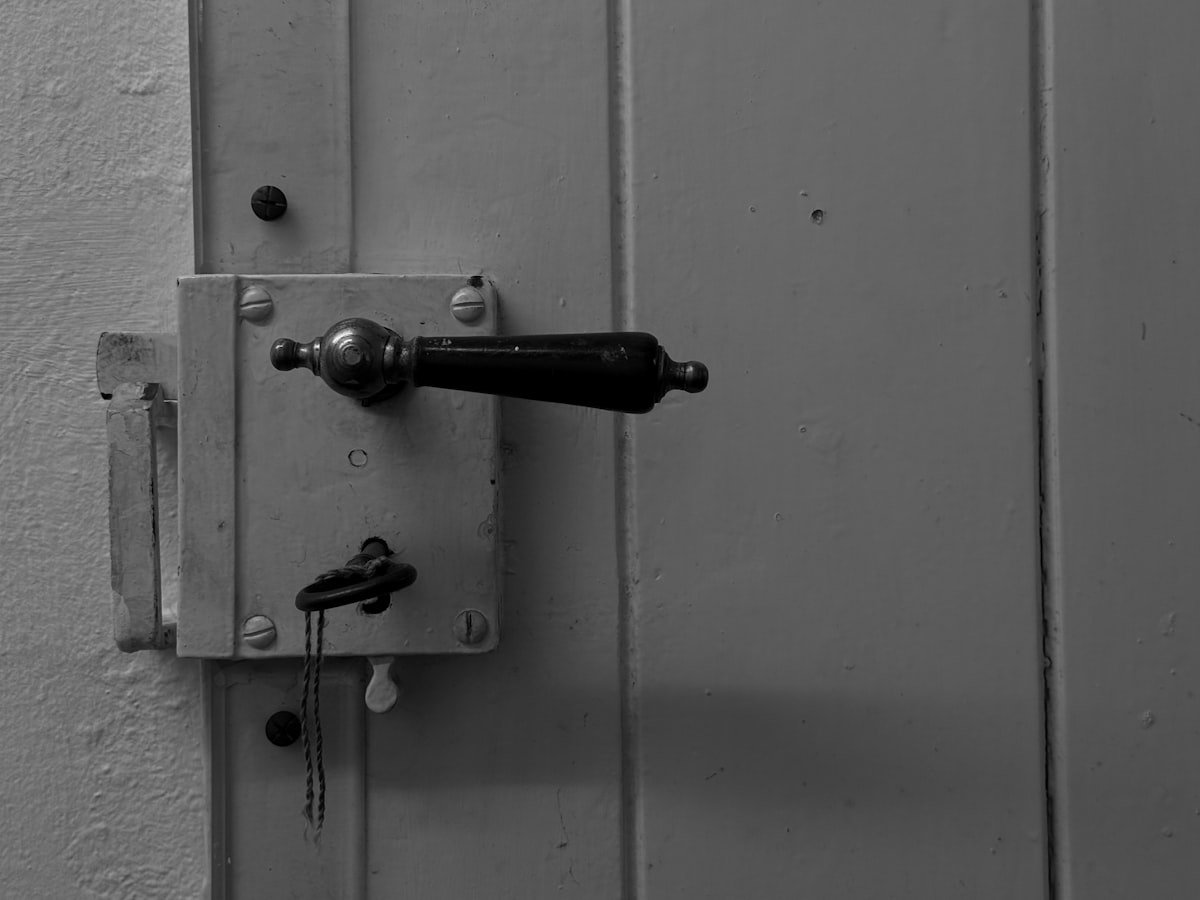 Door handle and lock with a key in the keyhole